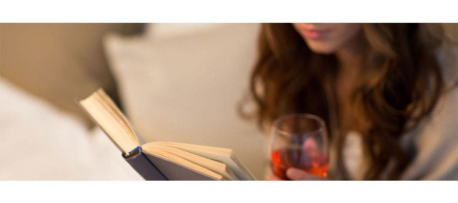 woman drinking sleepy girl mocktail and reading