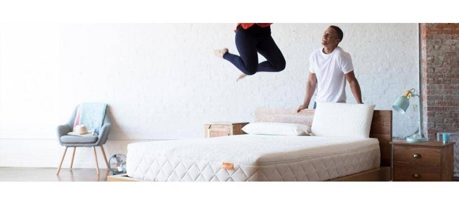 woman jumping on happsy organic mattress