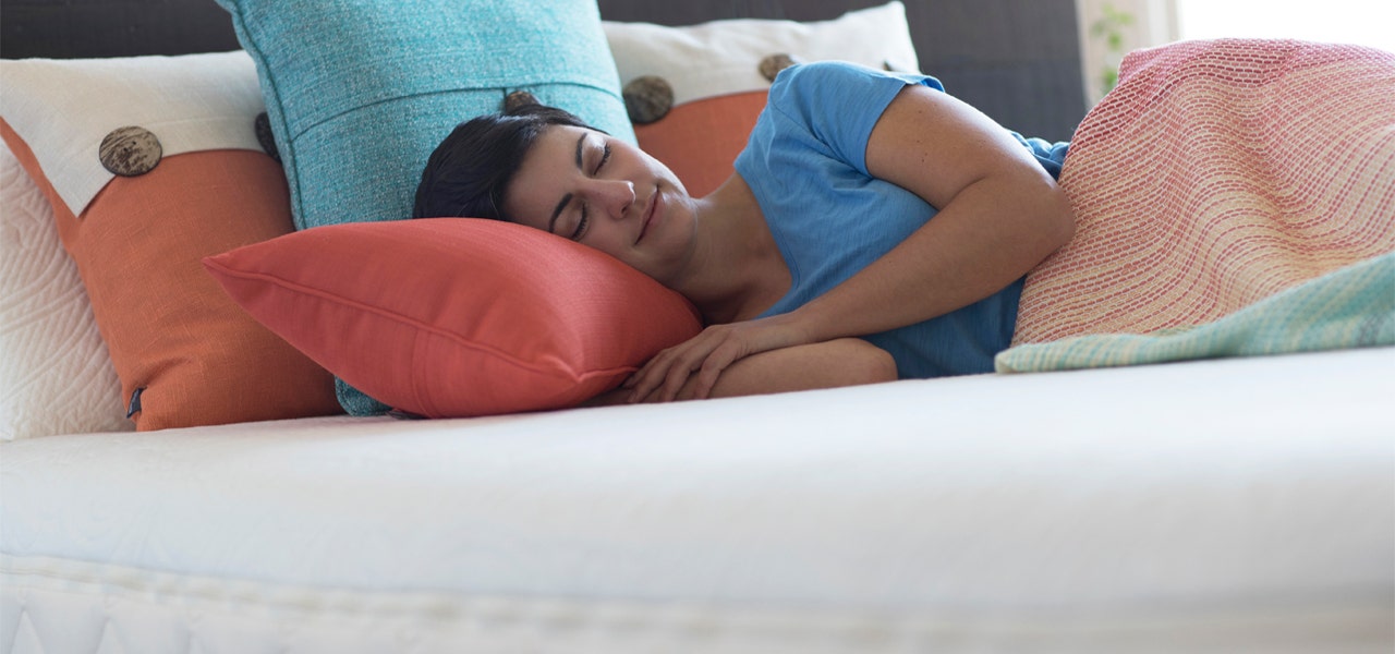 Young woman in a side sleeper position, content on her mattress