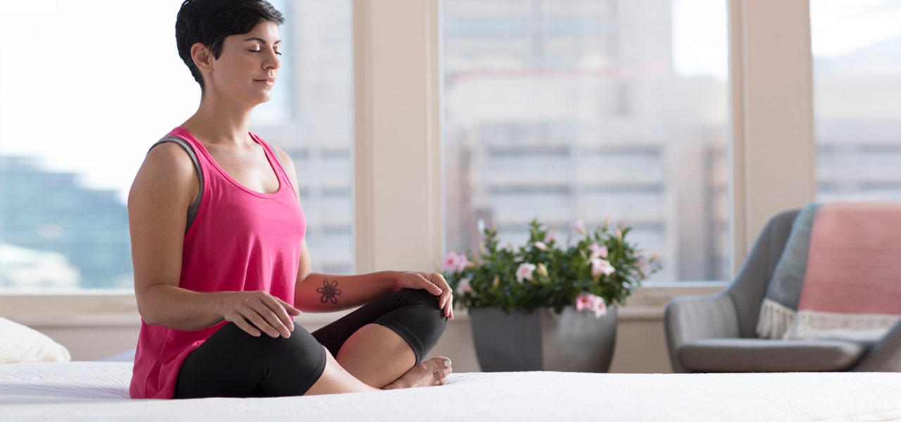 Woman in Easy Pose (Sukhasana) on her Happsy mattress