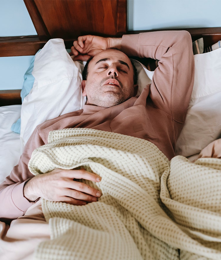 Man sleeping on a non-organic mattress containing common carcinogens