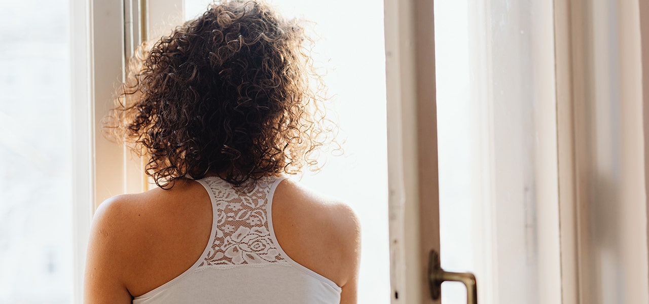 Woman looking out of a window that may contain lead