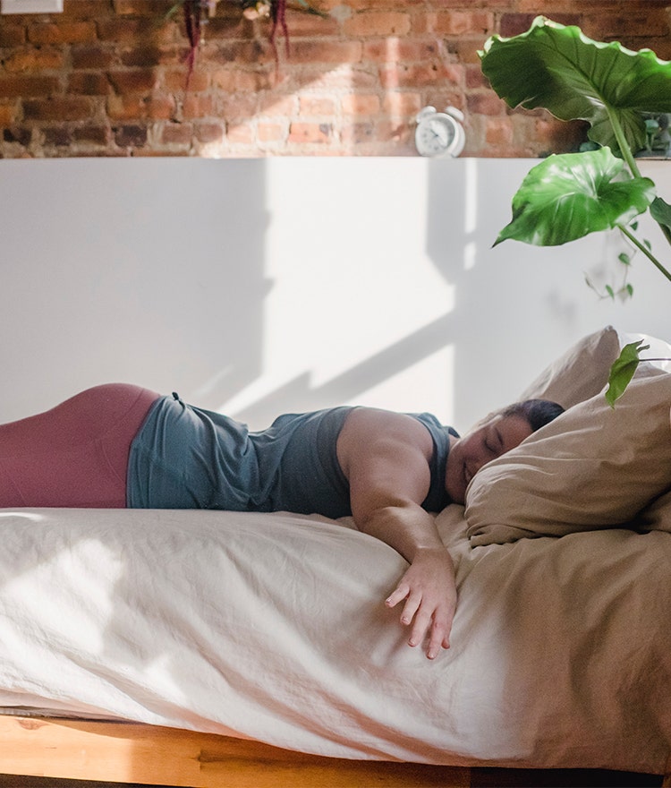 Woman lying on her stomach and smiling on an organic mattress