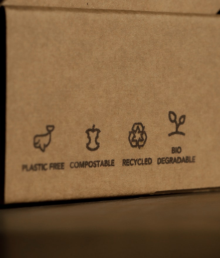 Cardboard product packaging with "plastic-free," "compostable," "recyclable" and "bio-degradable" claims