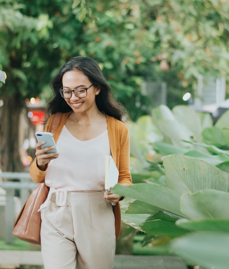 woman walking outside with phone
