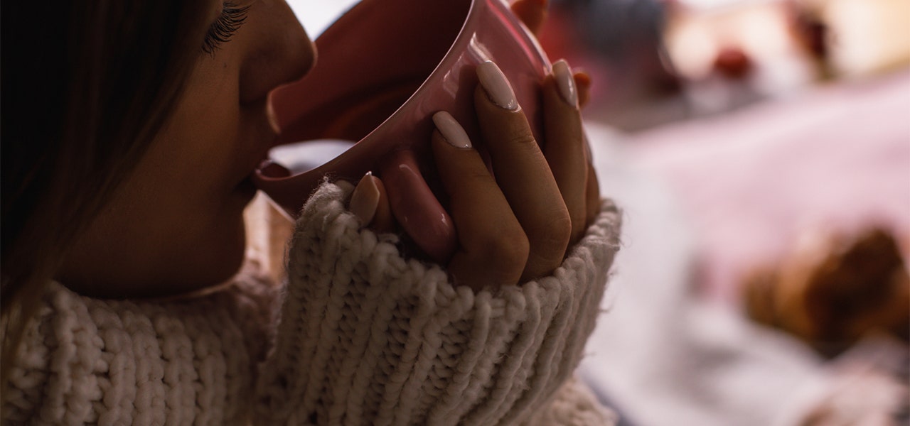 woman sipping a cup of tea