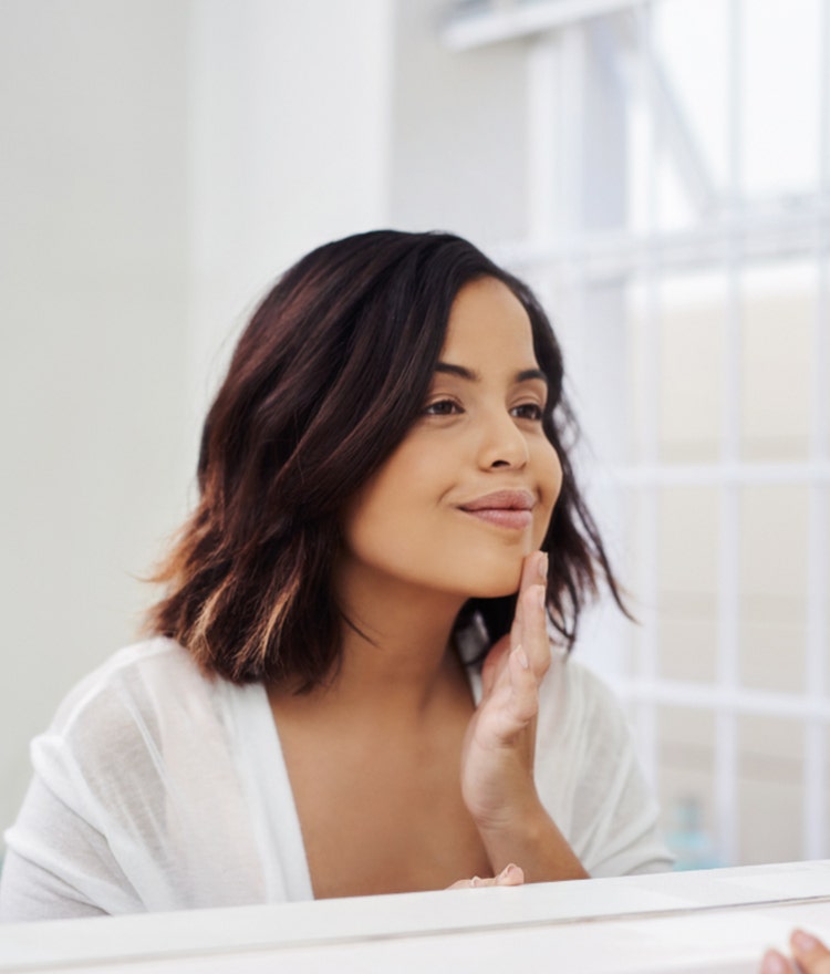 Woman practicing self-love with her skincare routine