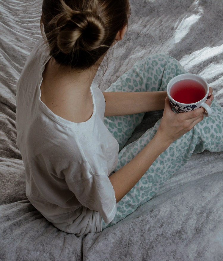 woman drinking sleepy girl mocktail in bed