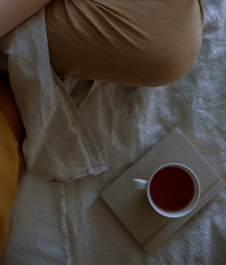 sleepy girl mocktail in bed on a book