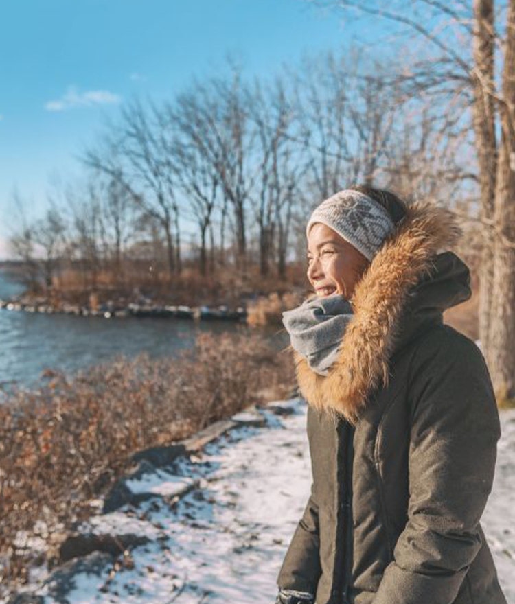 Woman outside laughing on a snowy day
