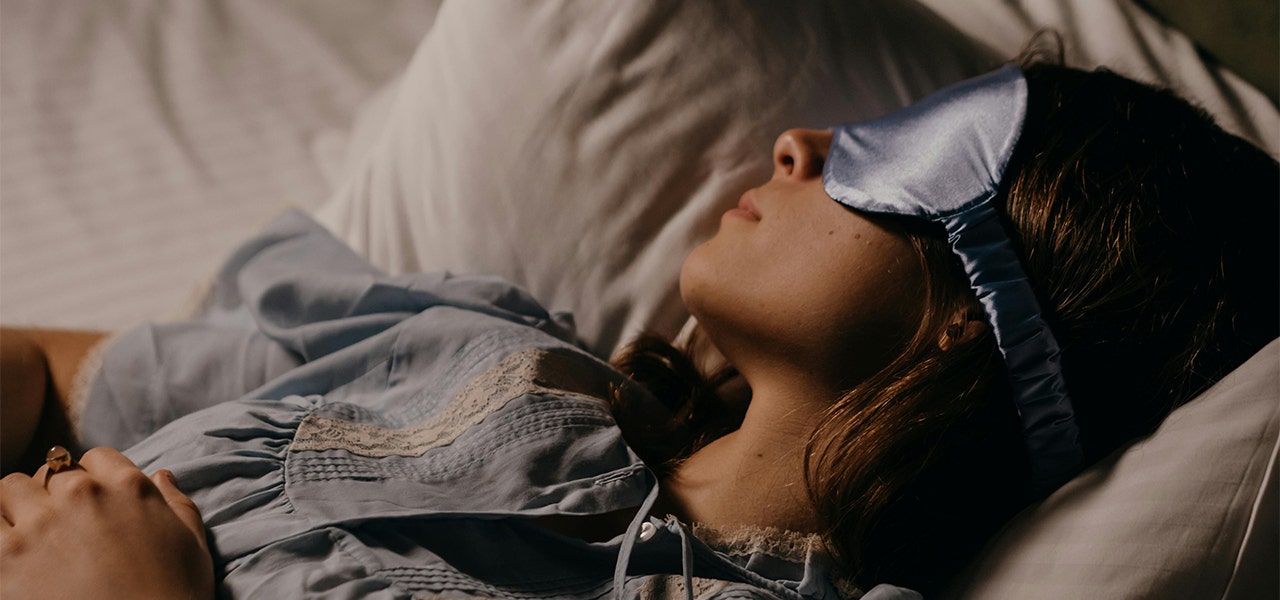 person sleeping with an eye mask on