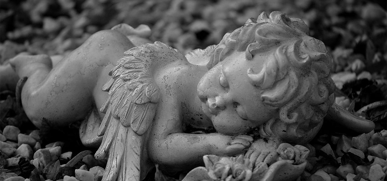 medieval angel statue sleeping