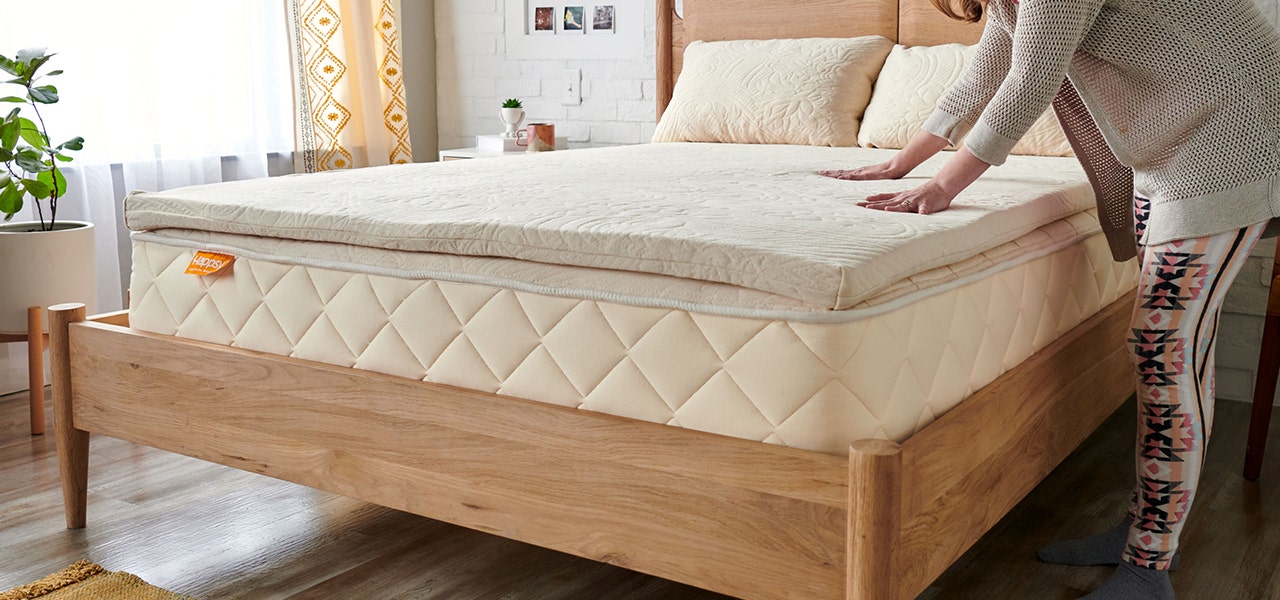 making the bed with a happsy organic latex mattress topper